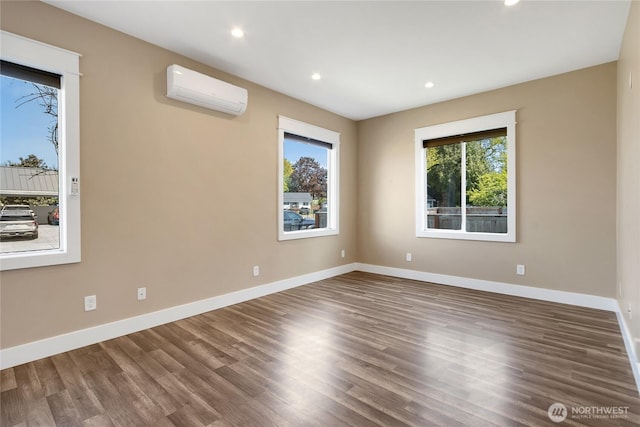 unfurnished room with a healthy amount of sunlight, recessed lighting, and wood finished floors