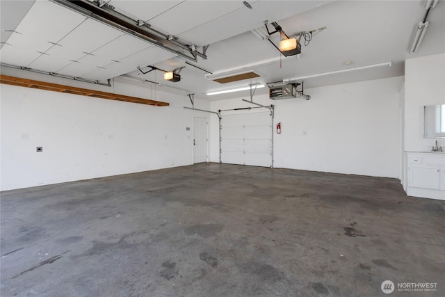 garage featuring a garage door opener and a sink