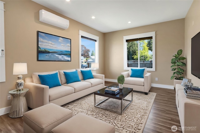 living area featuring baseboards, a wall mounted air conditioner, and wood finished floors