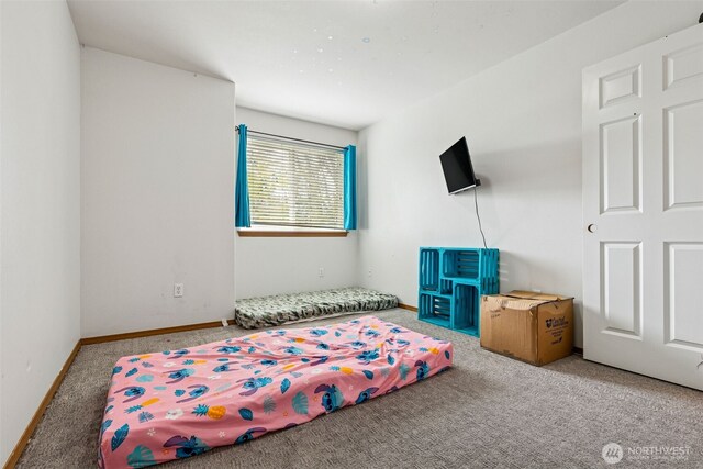 carpeted bedroom featuring baseboards