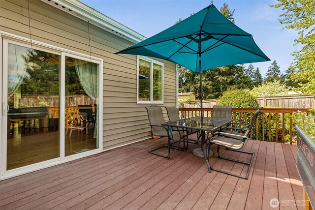 deck with fence and outdoor dining area