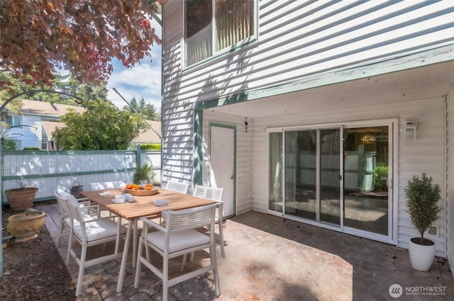 view of patio featuring fence and outdoor dining space