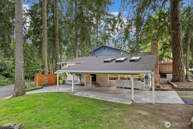 19542 6th Ave NE, Shoreline, WA 98155 - rear view of house featuring a chimney, roof with shingles, fence, a yard, and a patio