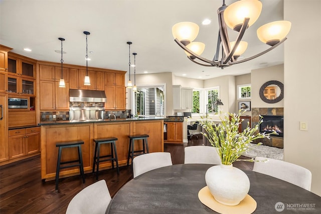24270 SE 147th Pl, Issaquah, WA 98027 - dining area with dark wood finished floors, recessed lighting, a chandelier, and a fireplace