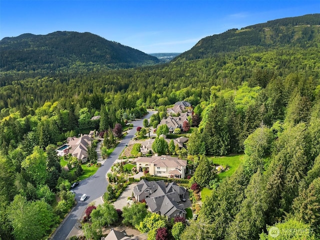 24270 SE 147th Pl, Issaquah, WA 98027 - aerial perspective of suburban area with a forest and a mountain backdrop