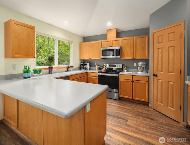 27627 NE 140th Pl, Duvall, WA 98019 - kitchen with dark wood-style flooring, a peninsula, light countertops, a sink, and appliances with stainless steel finishes