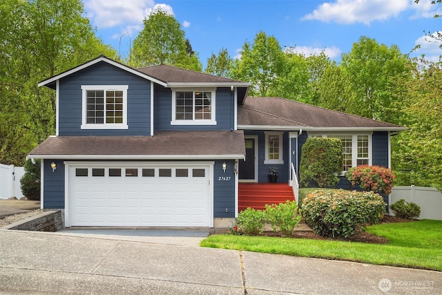 27627 NE 140th Pl, Duvall, WA 98019 - split level home with fence, roof with shingles, a garage, a porch, and concrete driveway