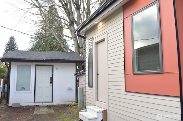 view of side of home with an outdoor structure