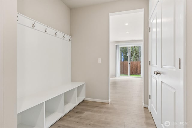 mudroom featuring baseboards and light wood finished floors