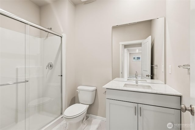 full bath with baseboards, vanity, toilet, and a shower stall