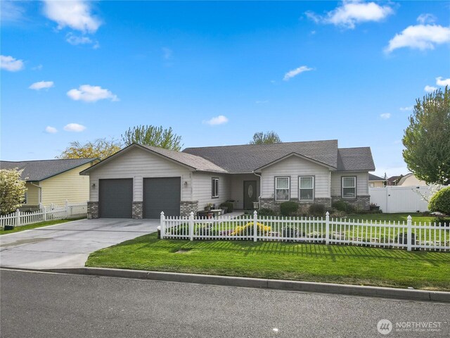 ranch-style home with a fenced front yard, a front lawn, stone siding, a garage, and concrete driveway