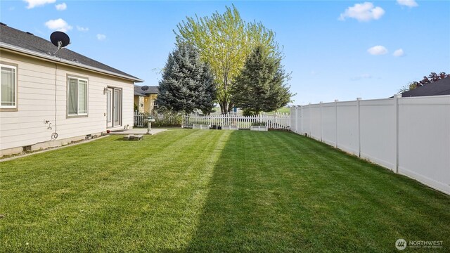 view of yard with a fenced backyard