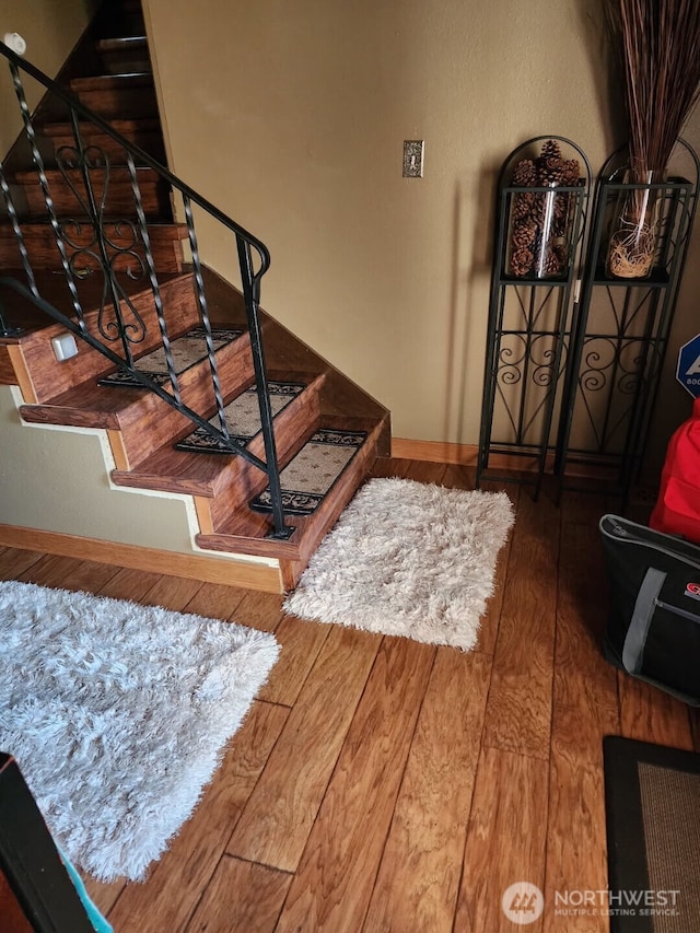 stairs featuring baseboards and hardwood / wood-style floors