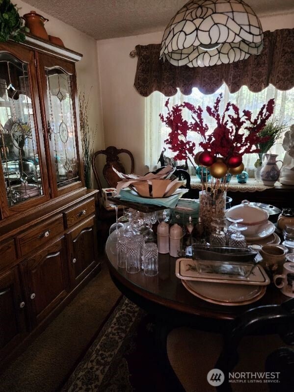 dining area featuring a textured ceiling