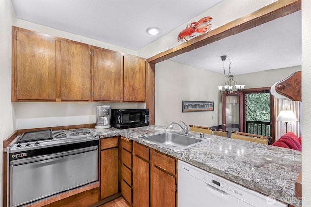 kitchen with black microwave, a sink, dishwasher, stainless steel range with electric stovetop, and a chandelier