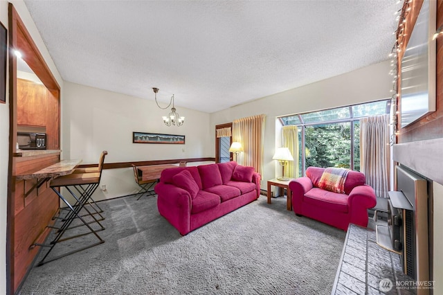 living area with carpet floors, a textured ceiling, and a notable chandelier