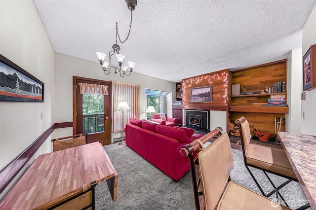 living room with a chandelier, a textured ceiling, a baseboard heating unit, and carpet