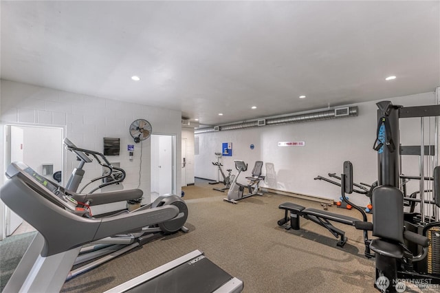 workout area featuring recessed lighting, concrete block wall, and visible vents