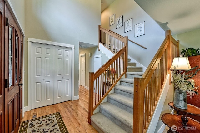 3506 S Grace Ln, Bellingham, WA 98226 - entrance foyer with baseboards, stairway, light wood-type flooring, and a high ceiling