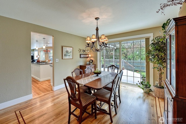 3506 S Grace Ln, Bellingham, WA 98226 - dining space featuring baseboards, light wood-style flooring, and a notable chandelier
