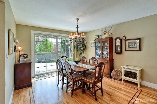 3506 S Grace Ln, Bellingham, WA 98226 - dining space featuring a chandelier, light wood-style flooring, and baseboards