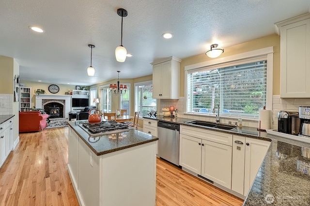 3506 S Grace Ln, Bellingham, WA 98226 - kitchen with light wood-style floors, appliances with stainless steel finishes, a sink, and tasteful backsplash
