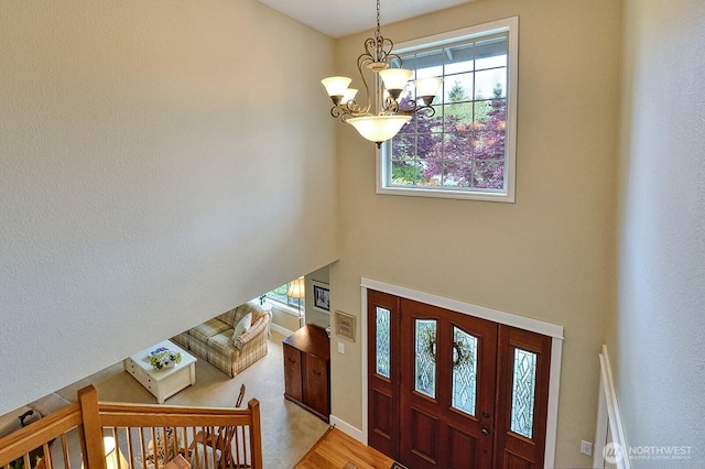 3506 S Grace Ln, Bellingham, WA 98226 - foyer featuring light wood-style floors, a chandelier, baseboards, and a towering ceiling