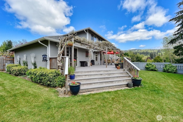 3506 S Grace Ln, Bellingham, WA 98226 - back of property featuring a lawn, a pergola, fence, and a deck