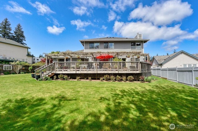 3506 S Grace Ln, Bellingham, WA 98226 - rear view of property with a chimney, a deck, a fenced backyard, and a lawn