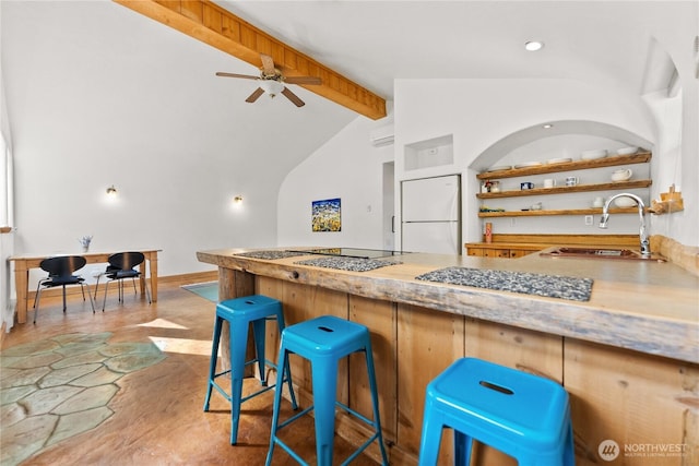 811 Filer Ave, Winthrop, WA 98862 - kitchen featuring open shelves, a sink, freestanding refrigerator, a ceiling fan, and vaulted ceiling with beams