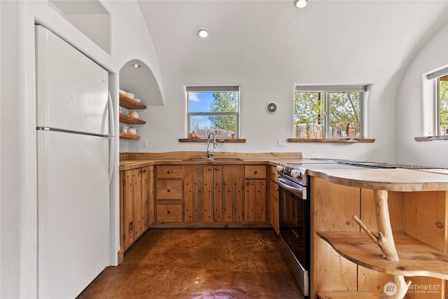 811 Filer Ave, Winthrop, WA 98862 - kitchen with a sink, finished concrete flooring, electric stove, freestanding refrigerator, and a wealth of natural light