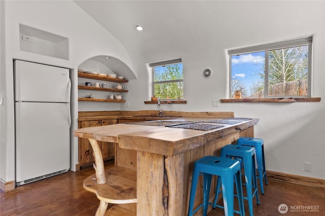 811 Filer Ave, Winthrop, WA 98862 - bar with freestanding refrigerator, lofted ceiling, recessed lighting, a sink, and concrete floors