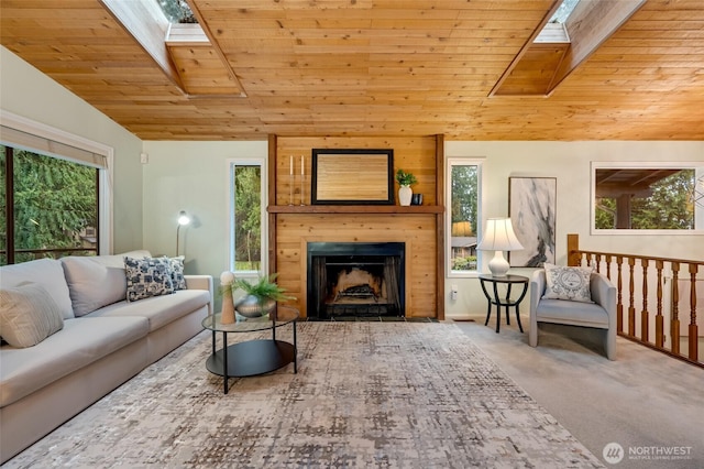 carpeted living room featuring vaulted ceiling with skylight, wood ceiling, and a fireplace