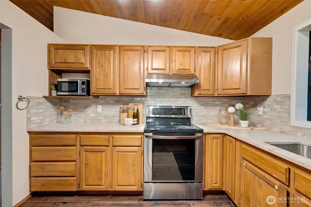 kitchen with dark wood-type flooring, under cabinet range hood, wooden ceiling, appliances with stainless steel finishes, and vaulted ceiling