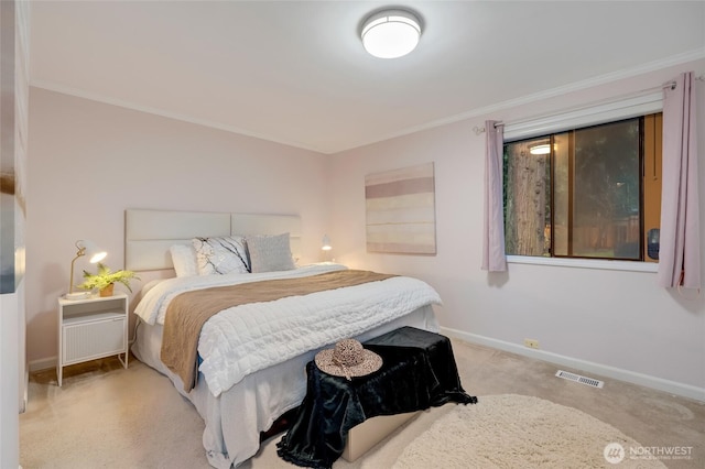 carpeted bedroom featuring baseboards, visible vents, and ornamental molding