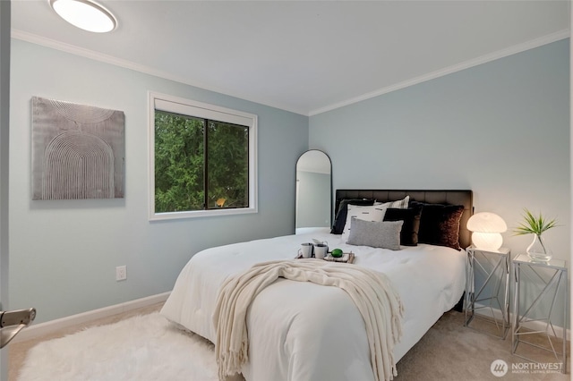 carpeted bedroom with baseboards and ornamental molding