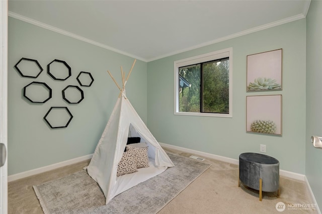 rec room featuring carpet flooring, baseboards, and ornamental molding