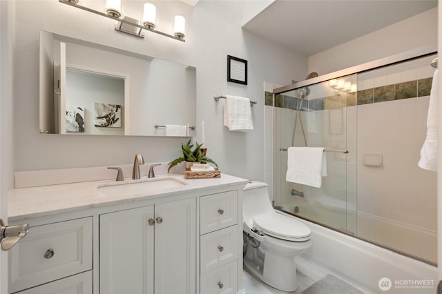 full bathroom with vanity, enclosed tub / shower combo, and toilet