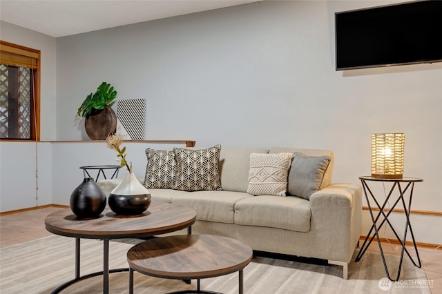 living area featuring baseboards