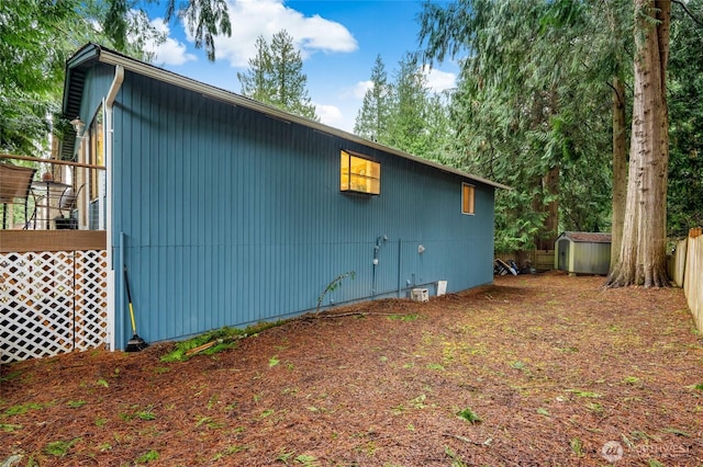 view of home's exterior with an outbuilding and a storage unit