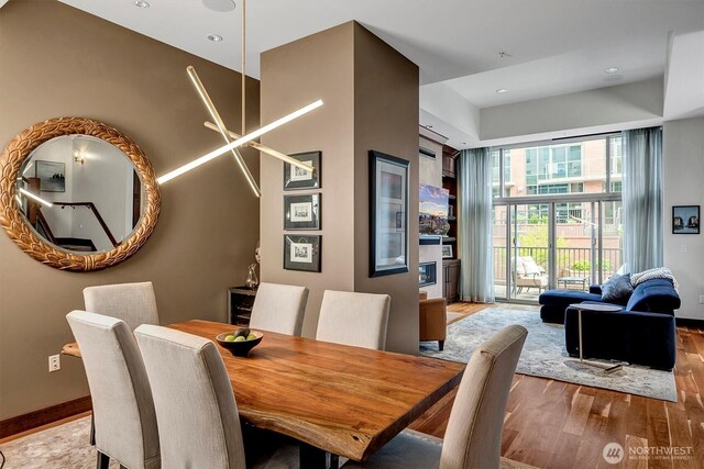 dining space featuring recessed lighting, baseboards, and wood finished floors