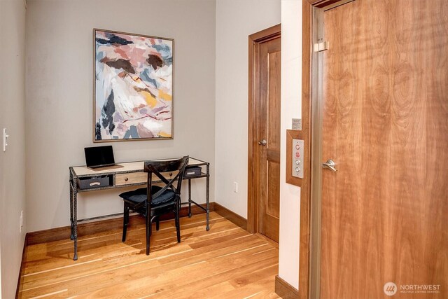 home office featuring light wood-type flooring and baseboards