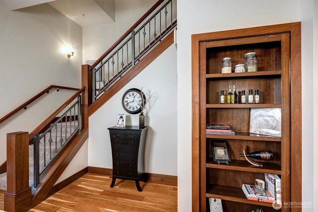 stairway featuring baseboards and wood finished floors