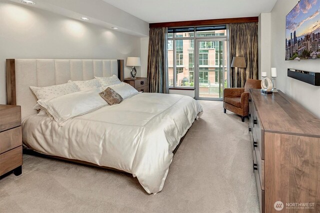 bedroom featuring light carpet and access to exterior