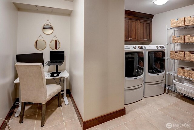 laundry area with baseboards, cabinet space, washing machine and dryer, and light tile patterned flooring