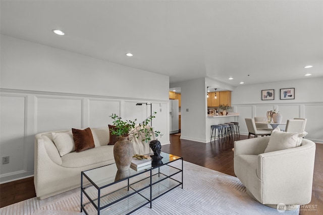 living room with wood finished floors, recessed lighting, wainscoting, and a decorative wall