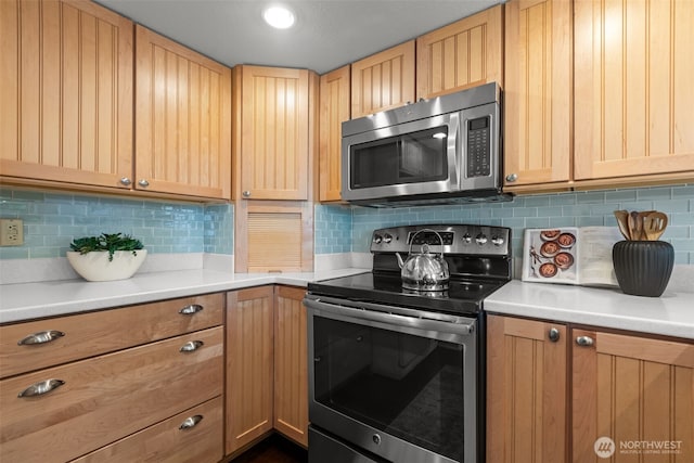 kitchen featuring light countertops, appliances with stainless steel finishes, decorative backsplash, and light brown cabinetry