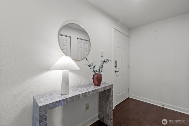 interior space with baseboards and dark wood finished floors