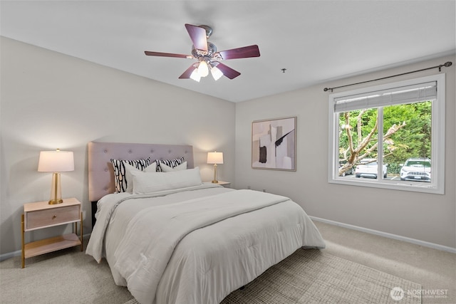bedroom featuring baseboards, light carpet, and a ceiling fan