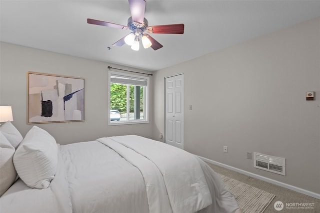 bedroom with baseboards, ceiling fan, carpet flooring, and visible vents